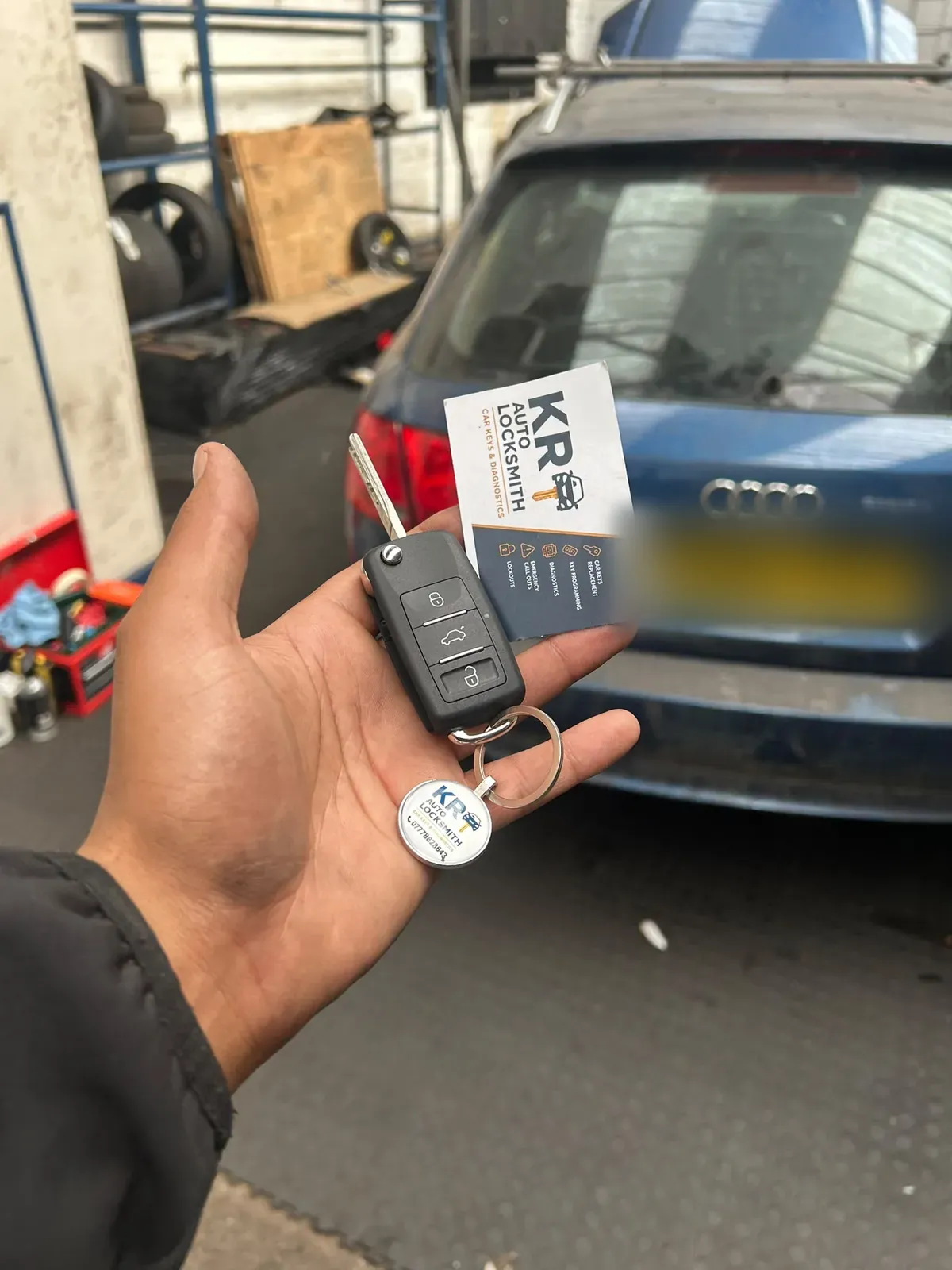 A new key cut for an Audi estate car in a vehicle workshop
