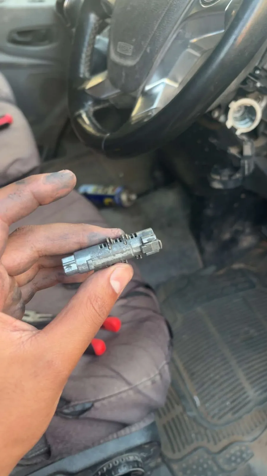 A worn ignition barrel removed from a steering column during an ignition repair